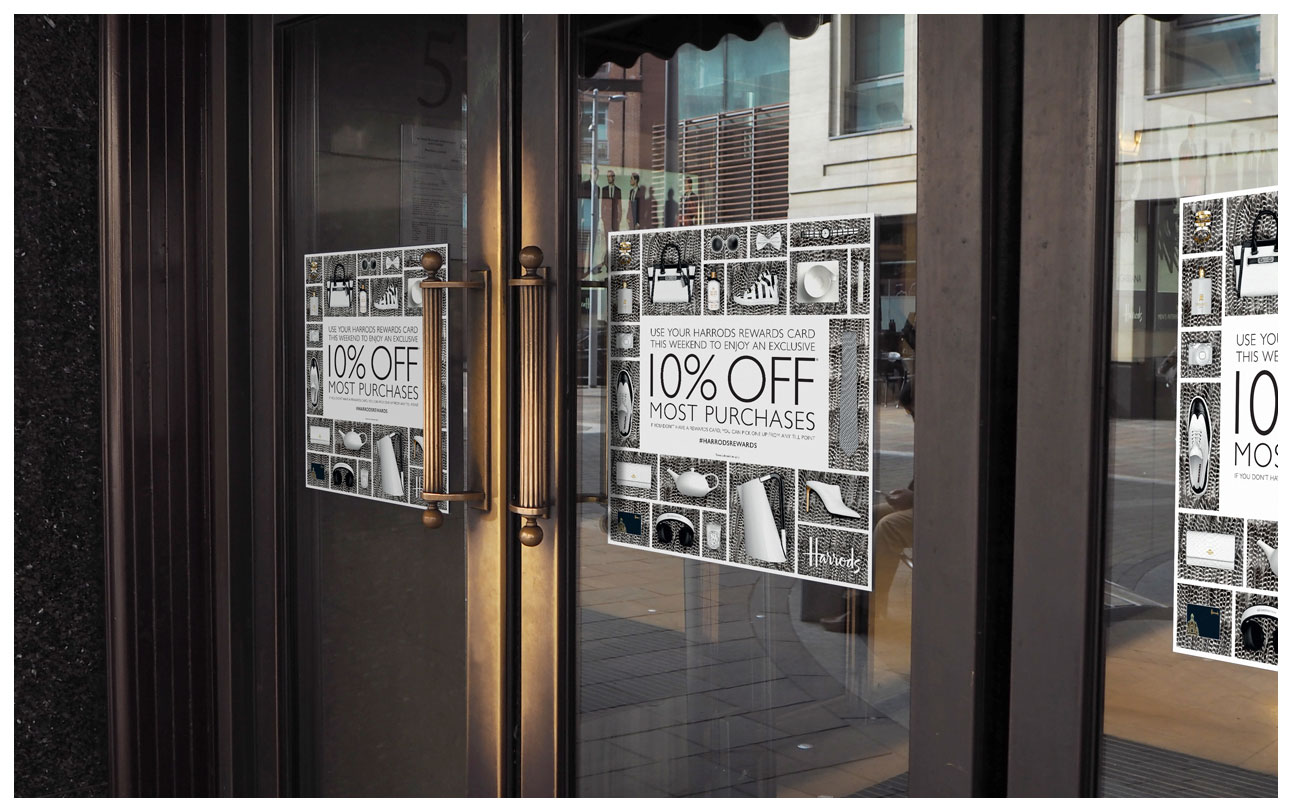 Door signs outside Harrods advertising the 10% weekend sale with black and white feathers as a background