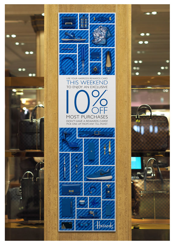 A photograph of a banner on a pillar in Harrods with blue products on matching blue pipes