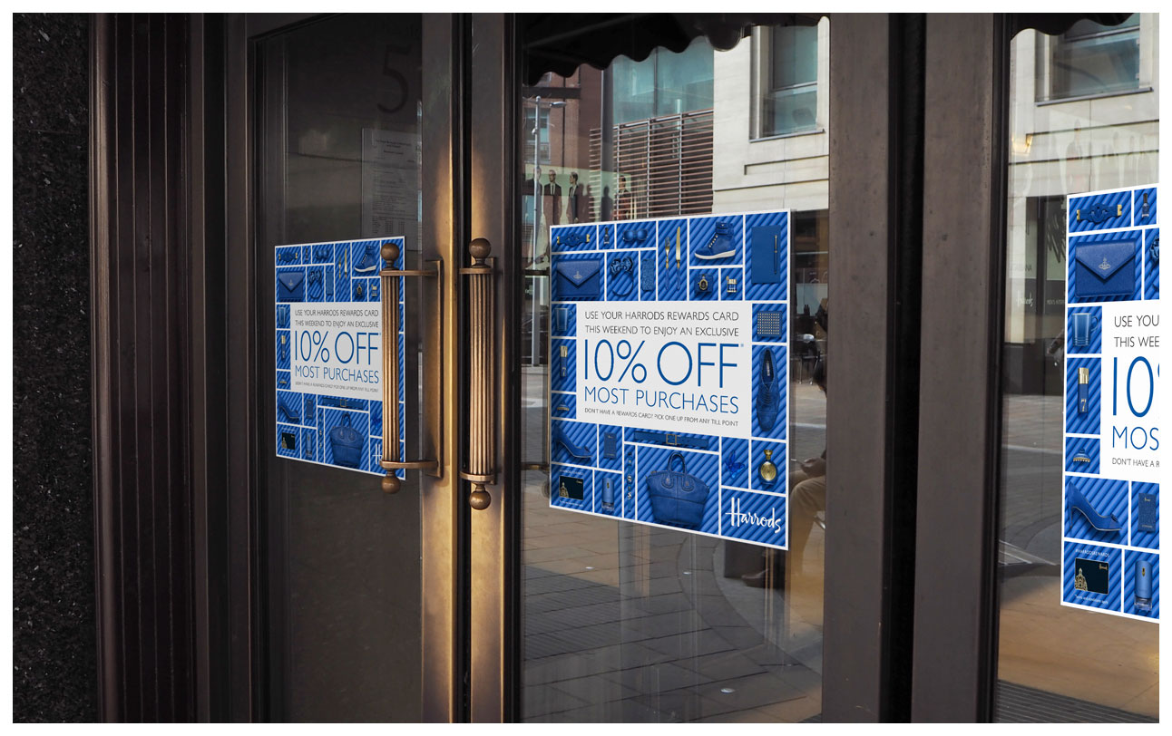 A photograph of door signs advertising the event with blue products on matching blue pipes