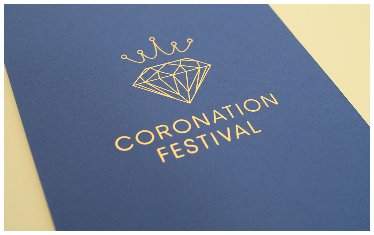 Photographo focussing on the Coronation Festival logo on the back of the invitation