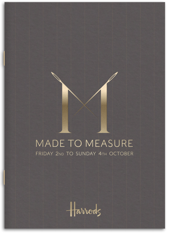 The cover of the event guide featuing a prominant satin gold foil logo on warm grey