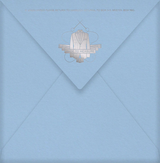 A pale blue envelope with MTM crest foiled on the flap in silver